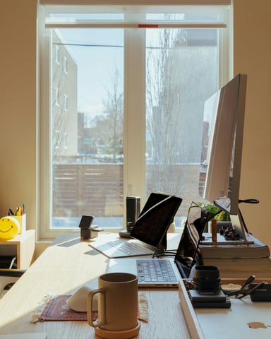Warm sunlit home office with iMac and coffee mug