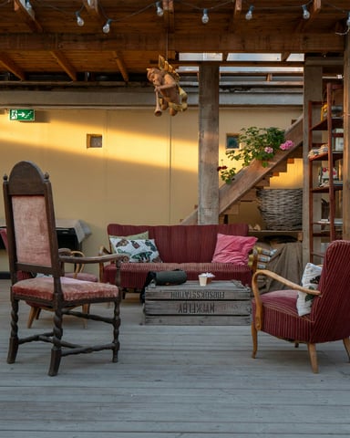 Rustic barn venue space with vintage seating and warm evening lighting
