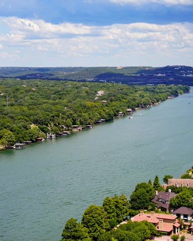 Aerial view of Lake Austin from Mount Bonnell with lush green hills