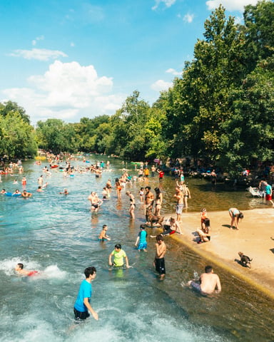 Barton Springs pool with swimmers on a sunny day