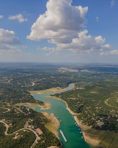 Aerial view of Texas Hill Country lake with turquoise water