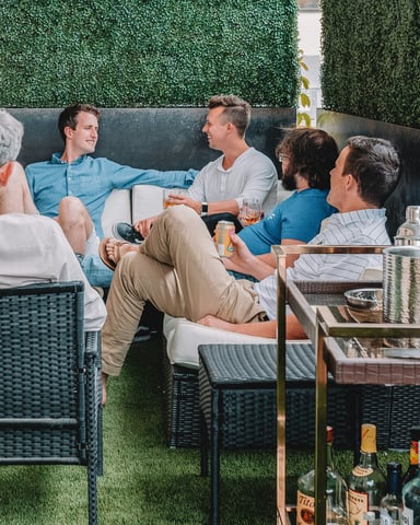 Group gathered on an outdoor patio with drinks for a retreat