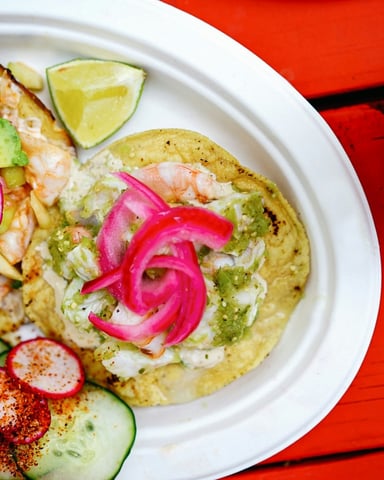 Shrimp tacos on a red table