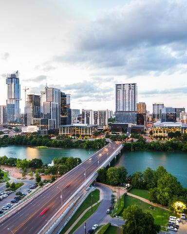 Austin skyline aerial view with Congress Avenue bridge and Colorado River at dusk