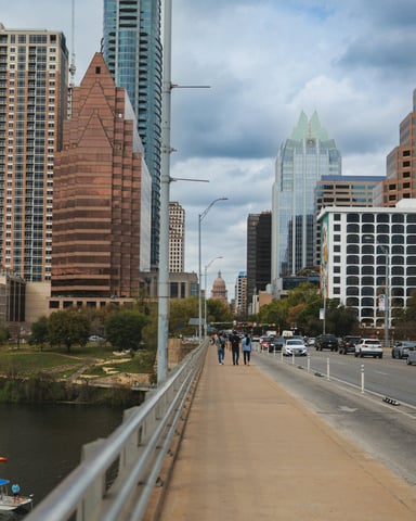 Congress Avenue Bridge walkway with the Texas Capitol in the background on a cool overcast day