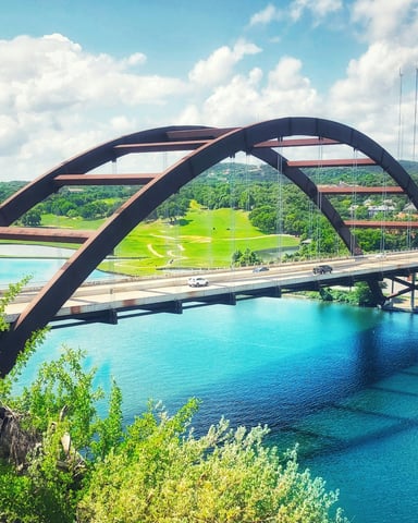 Pennybacker Bridge over vivid turquoise Lake Austin
