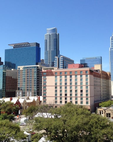 Downtown Austin skyline with mix of modern high-rises and historic buildings under clear blue sky